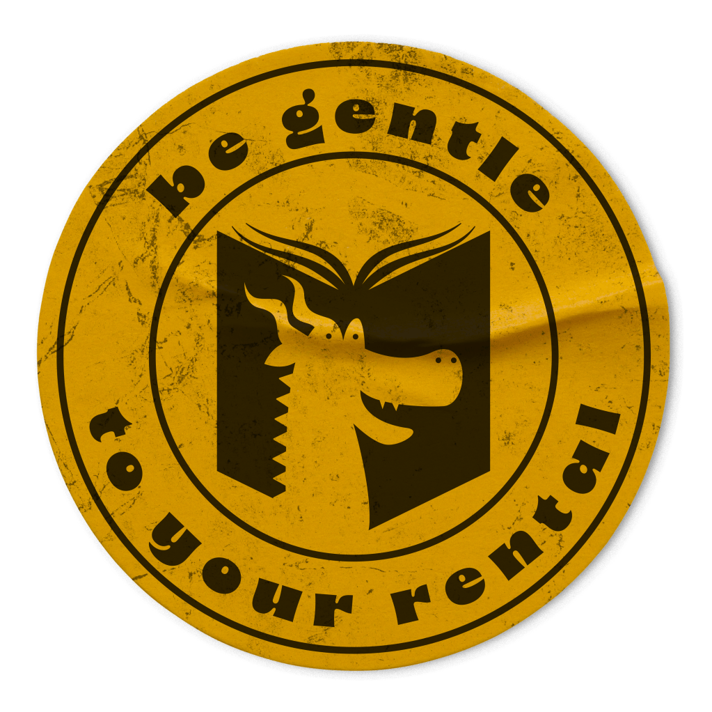 A dingy yellow sticker with a black logo on top that reads "be gentle to your rental" and has a silhouette of an open book with a derpy dragon's face on the cover.